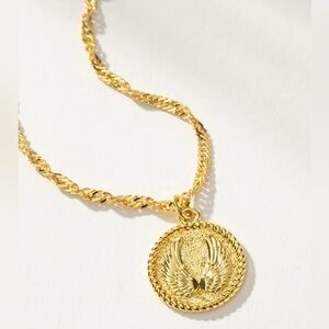 Uncommon James Gold Necklace with Winged Medallion. NWT. IN ORIGINAL PACKAGING.